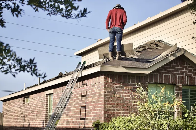 Professional roofer working on a residential roof in Colony Fairfield